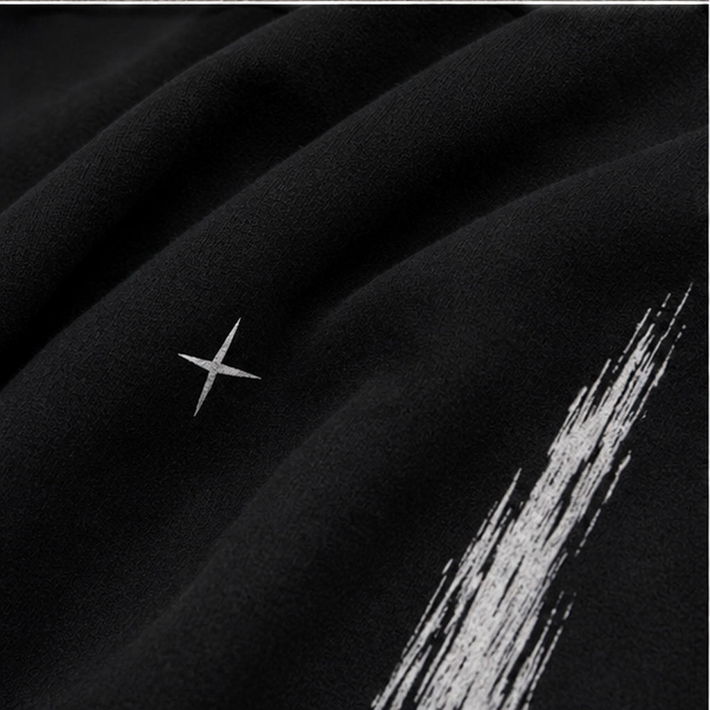 Vanta black fleece sweatpants fabric detail with white graffiti-inspired brushstroke print and small star accent