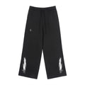 Vanta unisex black fleece sweatpants with white graffiti-inspired brushstroke prints and small star details.
